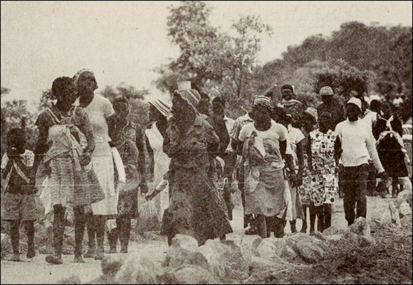 Refugees in Mozambique, walking along a road, 1980s